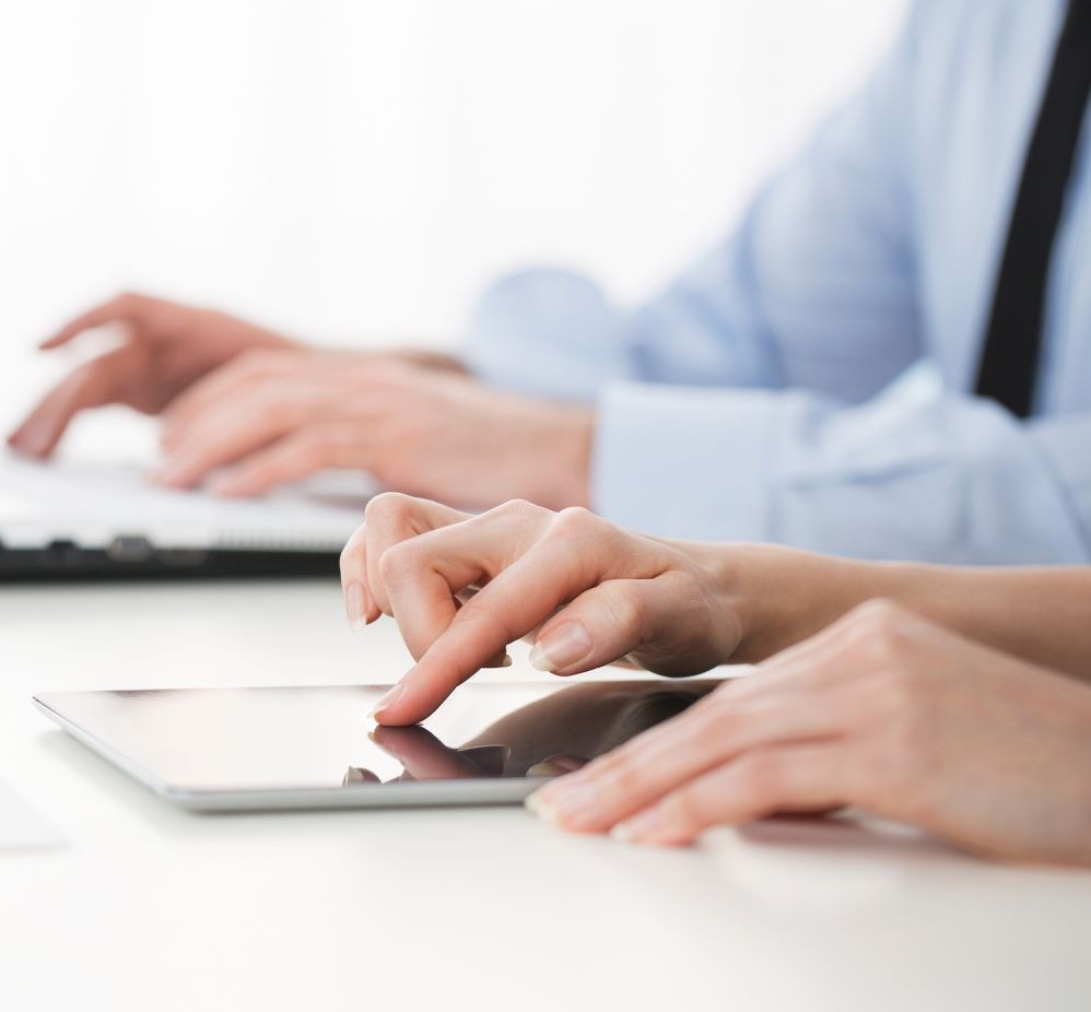 hands typing on devices
