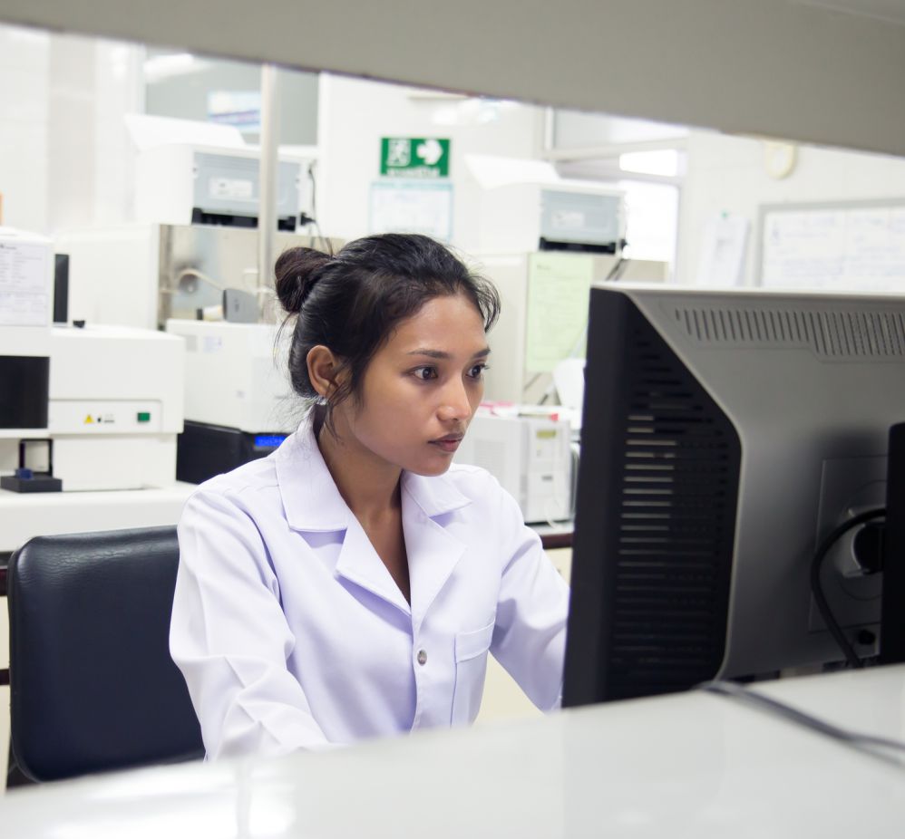 woman sitting at desk looking at a monitor