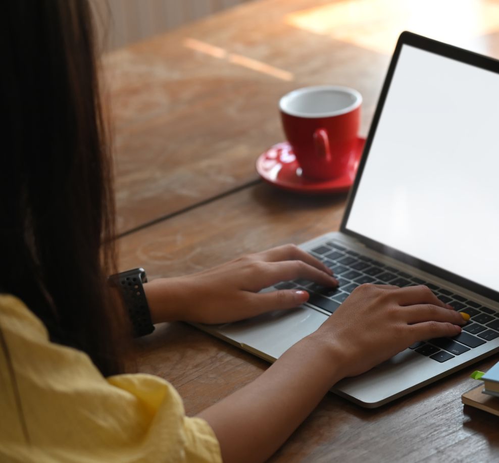 woman looking at laptop watching a webinar