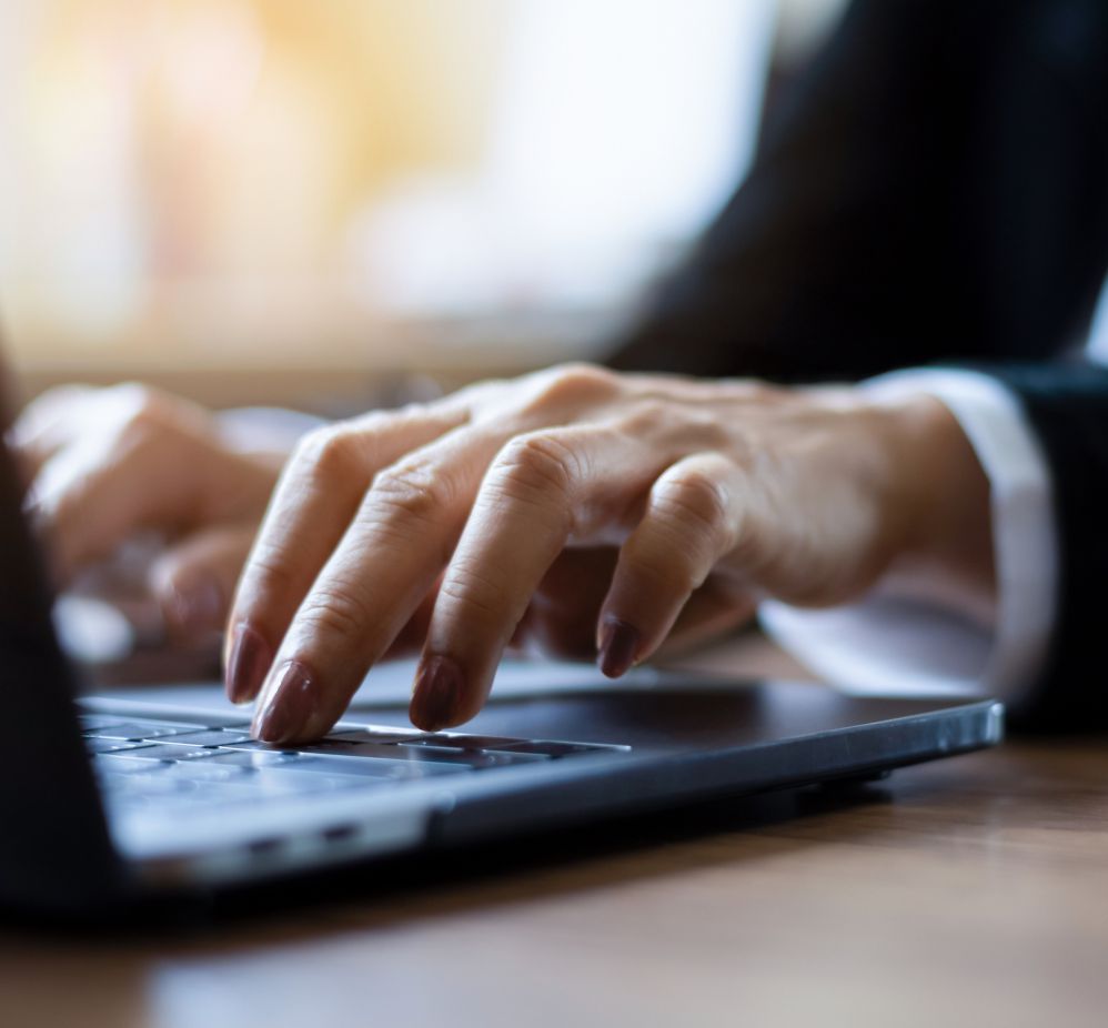 hands typing on a keyboard