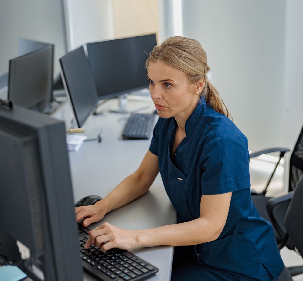 nurse typing at computer