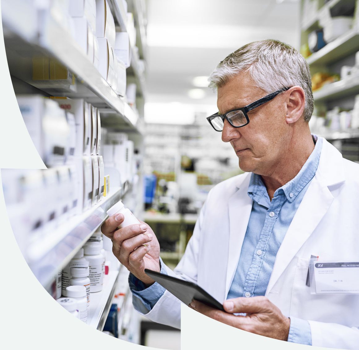 male pharmacists looking at pill bottle