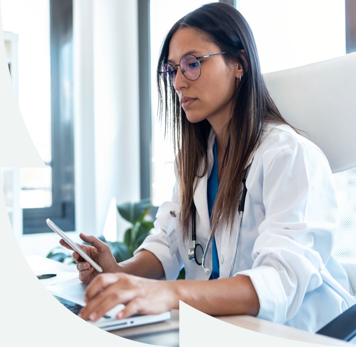 doctor sitting at desk on the computer